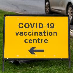 directional sign with words COVID-19 Vaccination Centre
